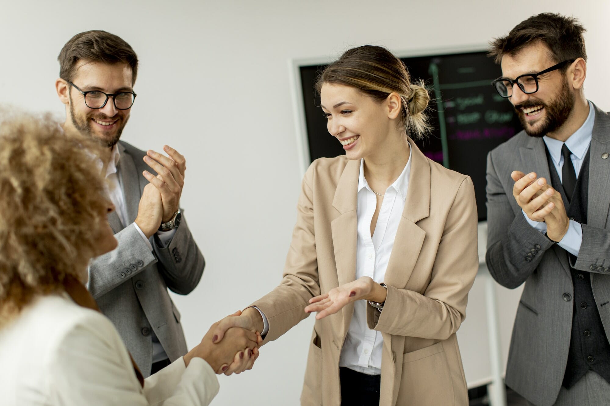 Group of young business people making a deal at a meeting in the office